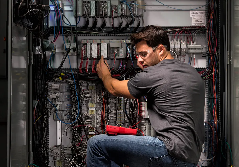 Technician inspecting process equipment