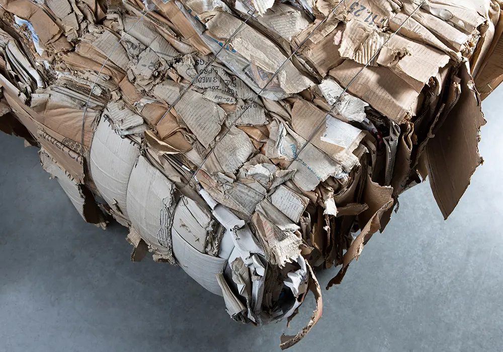 Compressed paper and cardboard feedstock